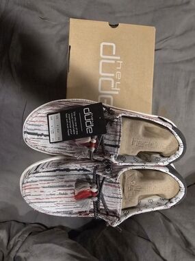 Hey Dude slip-on shoes in white, black & red woven pattern